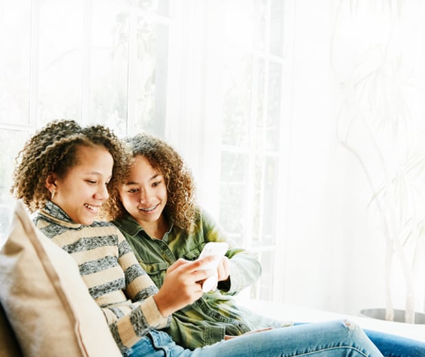 Resi Winback US June 2025 Two people relaxing with a smartphone
