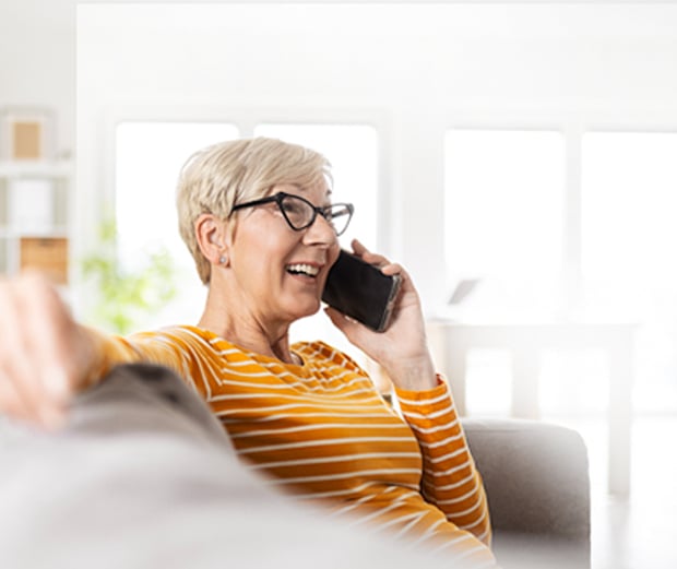 Woman sitting on the couch talking on a mobile phone