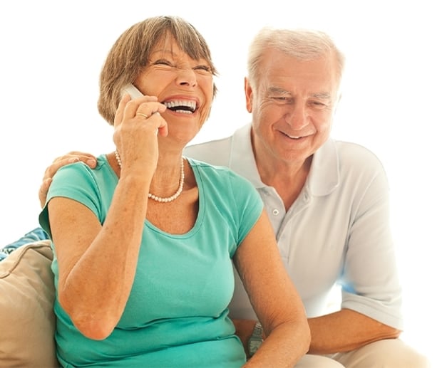 Residential Winback Header Domestic An older couple sitting on the couch having an enjoyable phone conversation